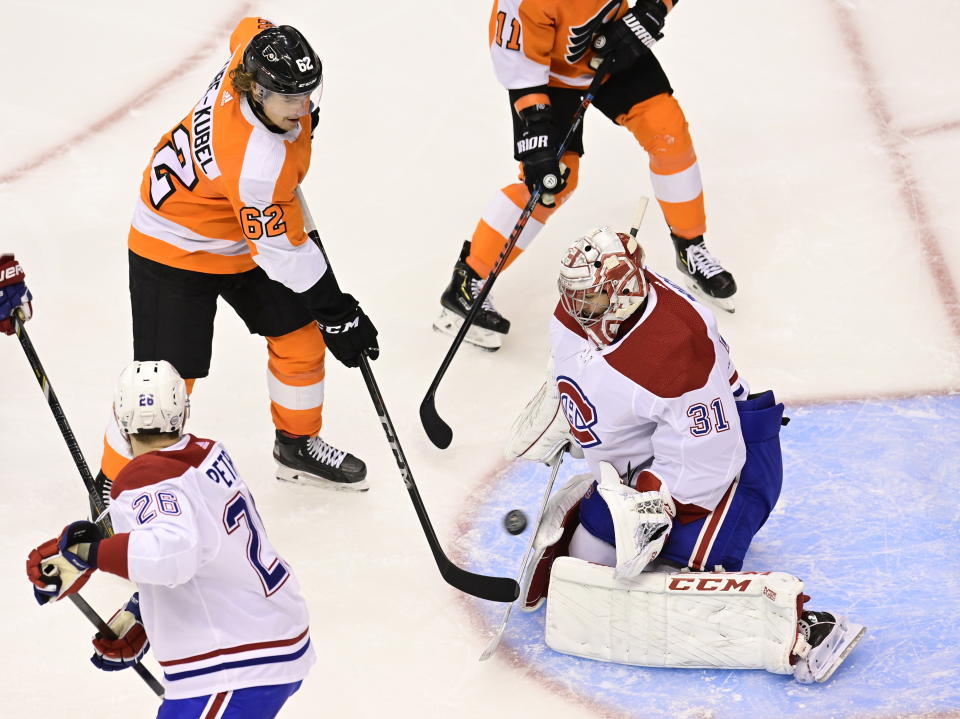 Montreal Canadiens goaltender Carey Price (31) stops Philadelphia Flyers right wing Nicolas Aube-Kubel (62) during the second period of an NHL Eastern Conference Stanley Cup hockey playoff game in Toronto, Friday, Aug. 14, 2020. (Frank Gunn/The Canadian Press via AP)