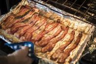 <p>Trying to make a nice breakfast for the family in a hectic environment? Instead of cooking bacon on the stovetop so that the hot grease makes a mess and you have to keep a constant eye on it, lay it out on a sheet pan with foil and <a href="https://www.delish.com/cooking/a22502749/how-to-cook-bacon-in-the-oven-recipe/" rel="nofollow noopener" target="_blank" data-ylk="slk:pop it in the oven;elm:context_link;itc:0;sec:content-canvas" class="link ">pop it in the oven</a>. It's easier, less messy, and arguably even tastier. </p>