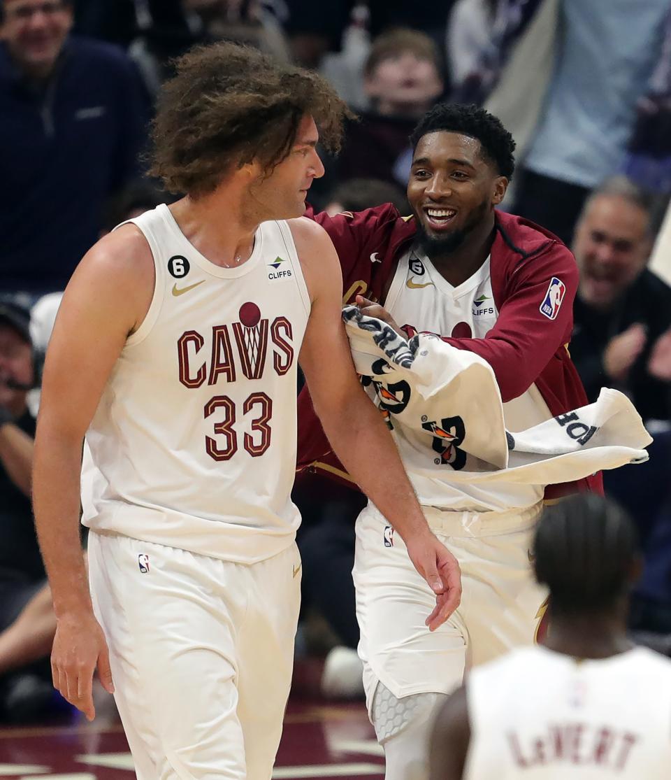 Cleveland Cavaliers guard Donovan Mitchell (45) celebrates with center Robin Lopez (33) during the second quarter of an NBA basketball game against the Washington Wizards at Rocket Mortgage FieldHouse, Sunday, Oct. 23, 2022, in Cleveland, Ohio.