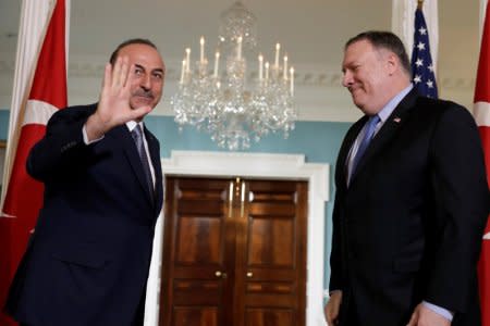 FILE PHOTO: Turkey's Foreign Minister Mevlut Cavusoglu (L) waves to the media before a meeting with U.S. Secretary of State Mike Pompeo (R) at the State Department in Washington, U.S., November 20, 2018. REUTERS/Yuri Gripas