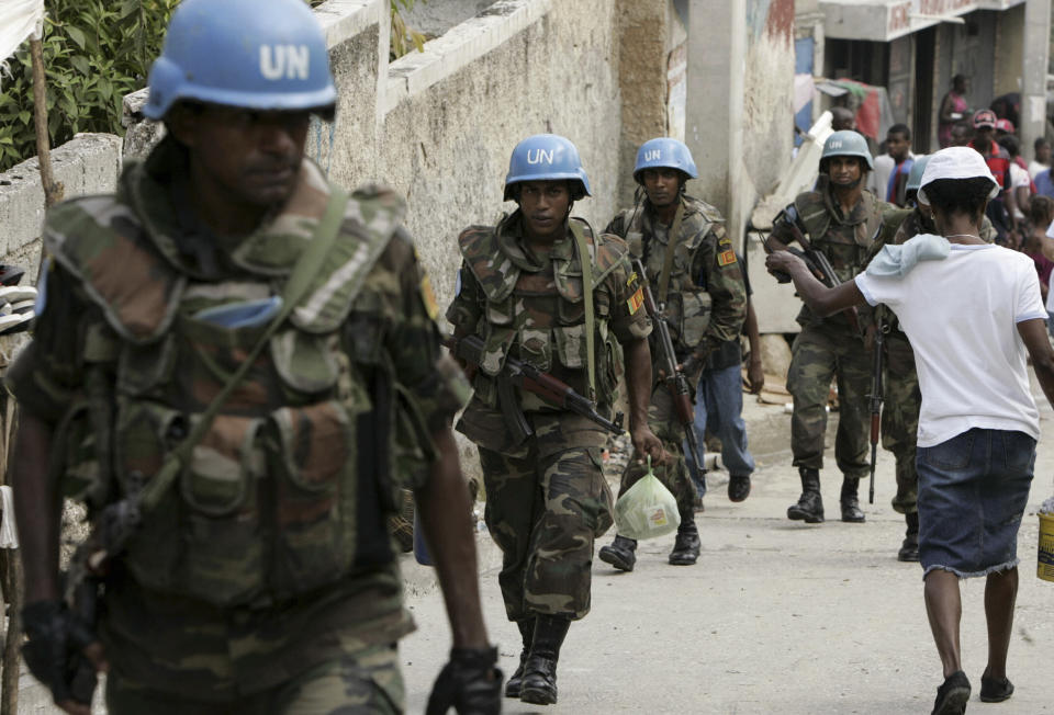 FILE - Members of MINUSTAH, a U.N. force established in 2004, patrol the Marttisant community in Port-au-Prince, Haiti, July 31, 2007. (AP Photo/Ariana Cubillos, File)