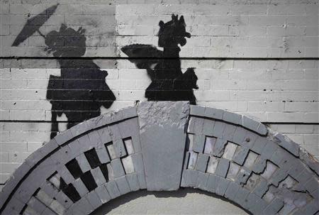 A new art piece by British graffiti artist Banksy is pictured in the Brooklyn borough of New York, October 17, 2013. REUTERS/Carlo Allegri