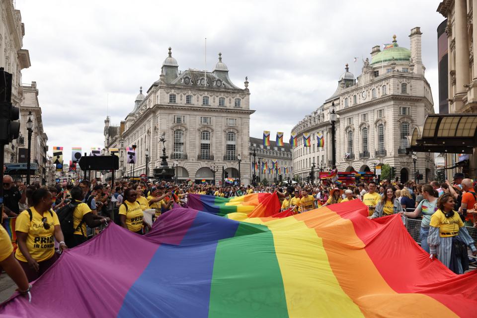 Members of the Lesbian, Gay, Bisexual and Transgender community carry a huge rainbow flag during the annual Pride Parade.