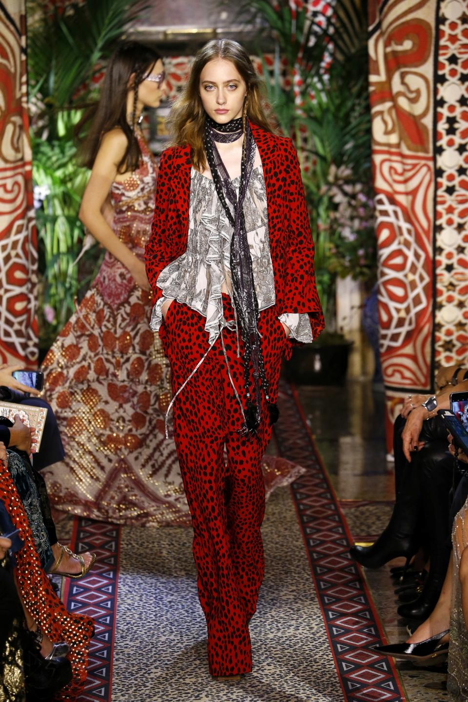 A model wears a matching leopard suit and sequin skinny scarf at the Roberto Cavalli Spring/Summer 2017 show