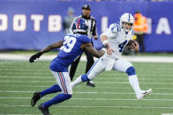 Indianapolis Colts quarterback Sam Ehlinger (4) runs away from New York Giants' Xavier McKinney (29) during the second half of an NFL football game, Sunday, Jan. 1, 2023, in East Rutherford, N.J. (AP Photo/Seth Wenig)