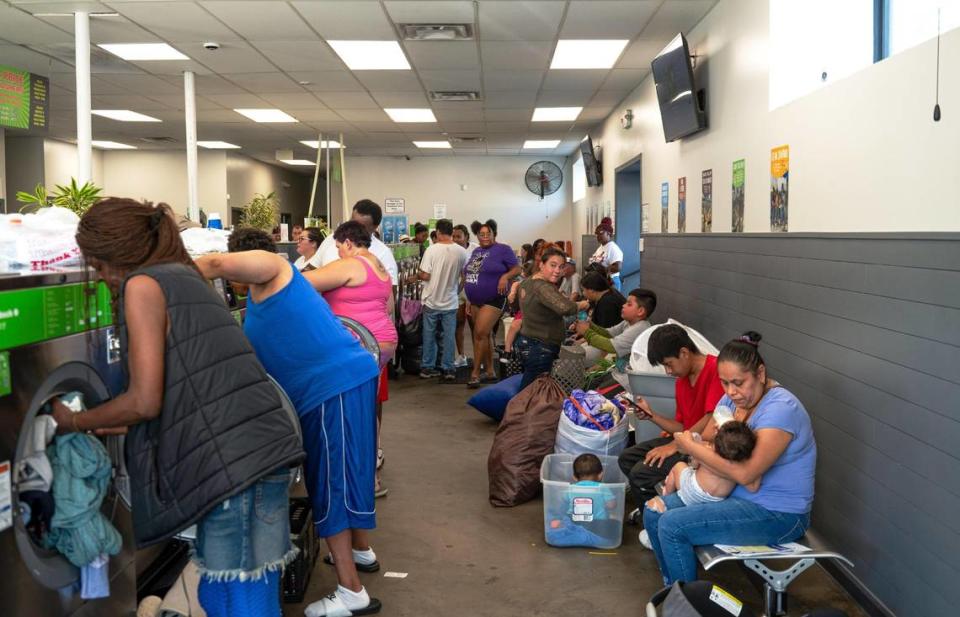 Customers at Community Laundry Day wash their clothes at Leah’s Laundromat on the Q. “This is just another place where we could actually help people out and be a resource,” John McPherson said.