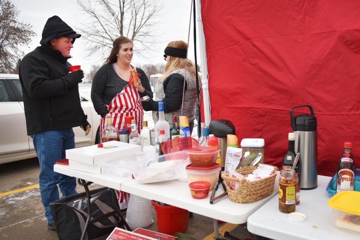 USD fans Scott Simons, from left, Zoey O&#x002019;Brien and Leah Jeseritz tailgate before a game against Western Illinois a few years ago at the DakotaDome in Vermillion. Students, today, are trying to change alcohol policies for home games this year.