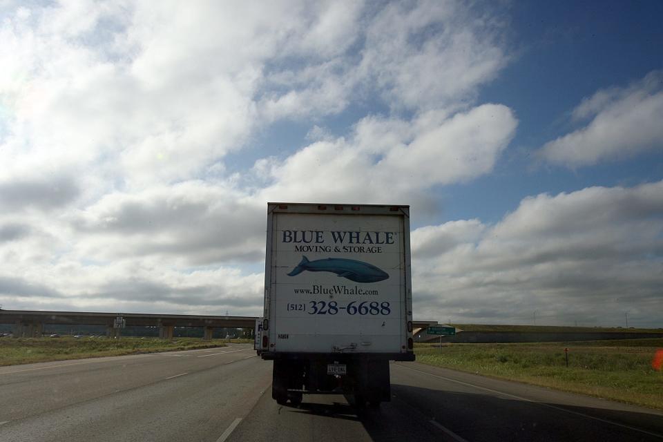 05.03.11 Alberto Martínez AMERICAN-STATESMAN -- Juan Alonzo and LeDon Lewis  drive their Blue Whale moving truck toward Bastrop. On this day they were moving the contents of a house near Bastrop to the owner's new house near Cedar Park. 0515moving