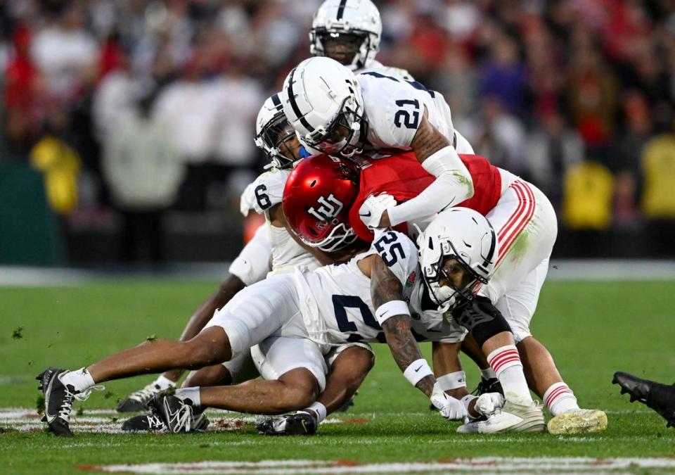 Penn State’s Daequan Hardy, Zakee Wheatley and safety Kevin Winston Jr. stop Utah quarterback Cam Rising during the Rose Bowl game on Monday, Jan. 2, 2023. Rising left the game after the play.