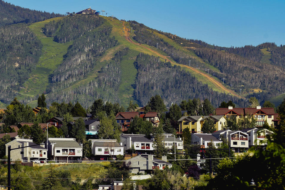 Houses dot the landscape at Colorado's Steamboat Ski Resort, Wednesday, Aug. 3, 2022, in Steamboat Springs, Colo. The city council passed a rule in June that could prove to be a model for other vacation towns: A ban on new short-term rentals in most of the city and a ballot measure to tax bookings at 9% to fund affordable housing. (AP Photo/Thomas Peipert)
