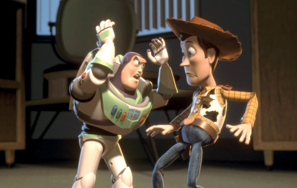 Buzz Lightyear and Woody from Toy Story are in an animated scene where Buzz is energetically talking to a surprised Woody