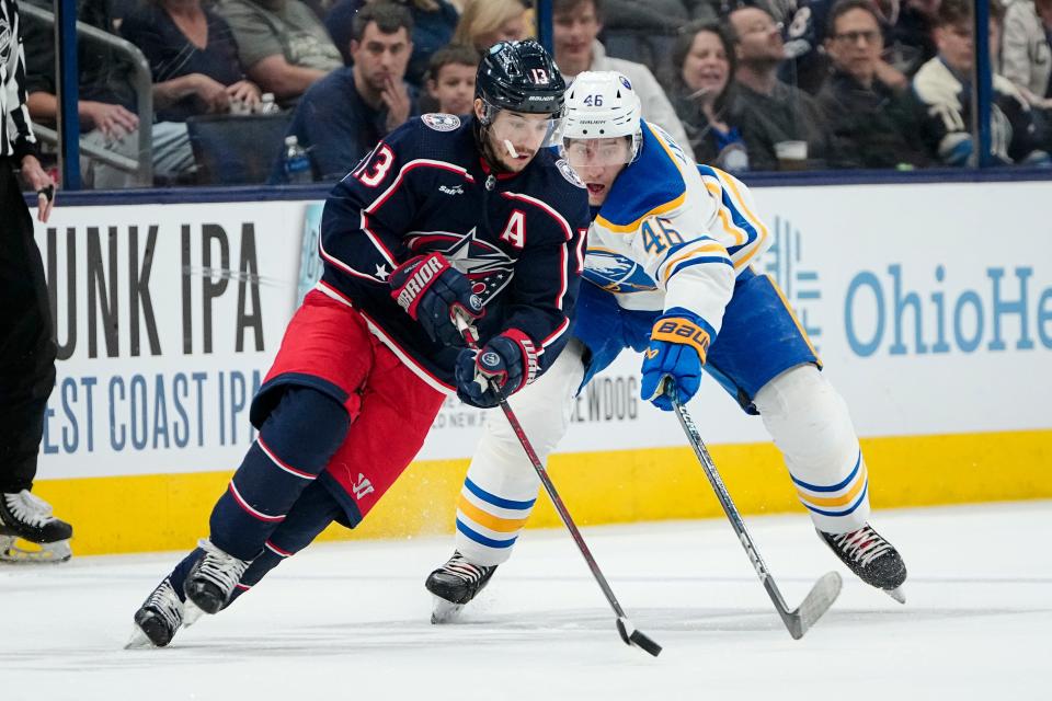 Columbus Blue Jackets left wing Johnny Gaudreau (13) skates past Buffalo Sabres defenseman Ilya Lyubushkin (46) during the second period of the NHL hockey game at Nationwide Arena in Columbus on April 14, 2023.