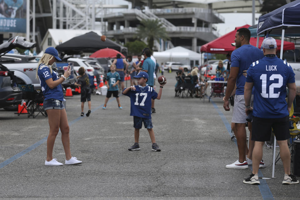 Fans tailgate before an NFL football game between the Jacksonville Jaguars and the Indianapolis Colts, Sunday, Sept. 13, 2020, in Jacksonville, Fla. (AP Photo/Stephen B. Morton)