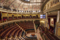 Empty seats of Spanish parliament's lower house in Madrid, Spain, Tuesday, March 10, 2020. The Spanish parliament's lower house has cancelled its activities for a week after a prominent lawmaker from the upstart far-right Vox Party tested positive for the COVID-19. (AP Photo/Bernat Armangue)