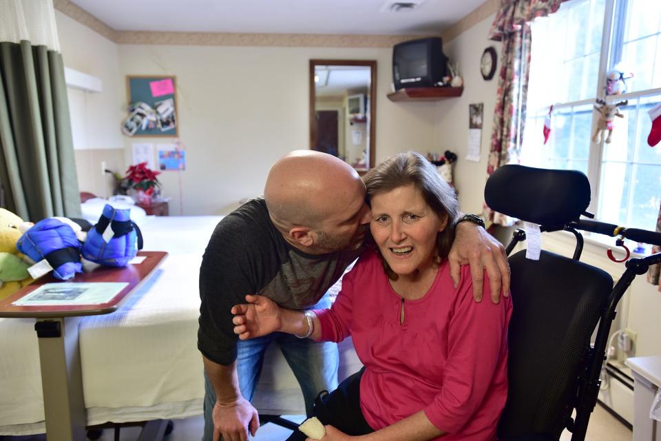 Glenn Prettitore kisses his wife, Kerrie, at the Ridgewood nursing home where she resided after a chemotherapy treatment caused brain damage. She was born with DPD deficiency, a rare genetic disorder that affects the body's metabolism of a type of chemotherapy. The  mother of three died in 2018.