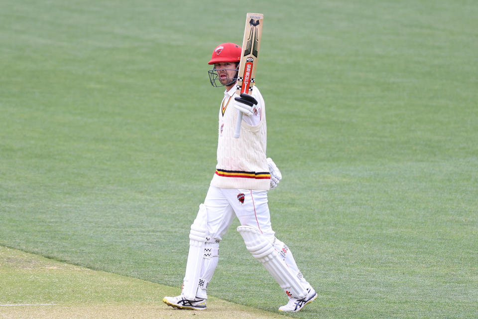 Travis Head (pictured) celebrates his fifty during day two of a Sheffield Shield match.