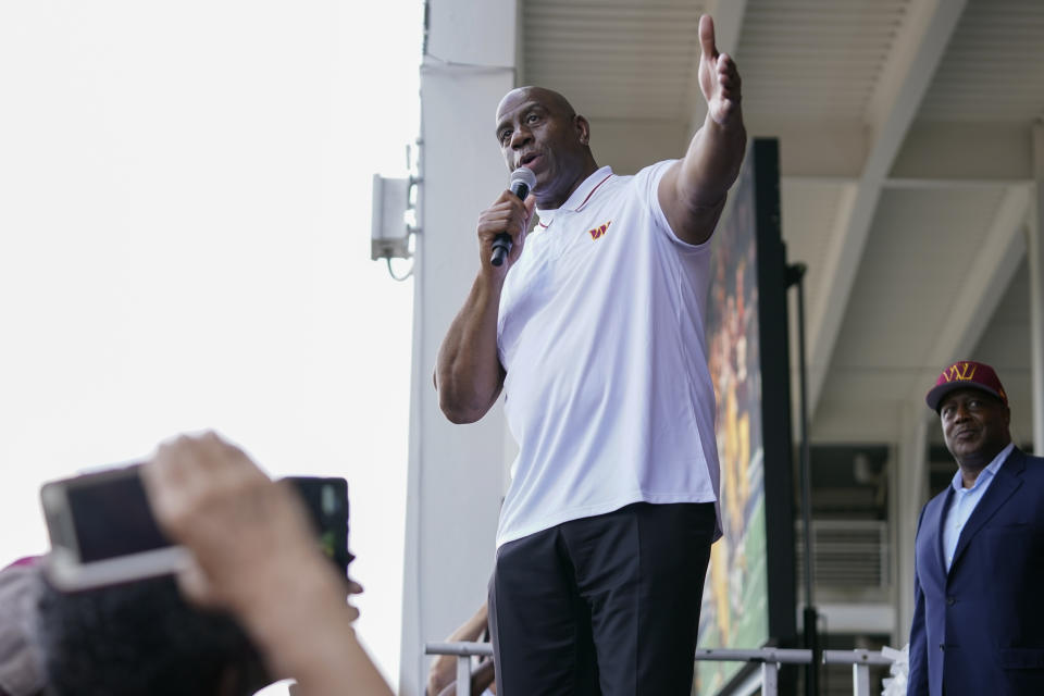 Magic Johnson, a member of the group buying the Washington Commanders, speaks at an NFL football pep rally at FedEx Field in Landover, Md., Friday, July 21, 2023. (AP Photo/Stephanie Scarbrough)