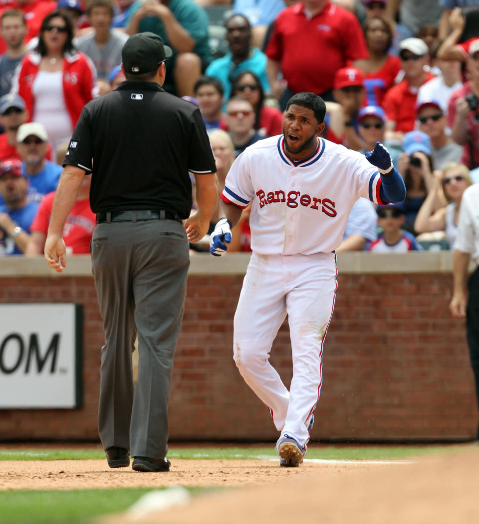 ARLINGTON, TX - MAY 12: Elvis Andrus #1 of the Texas Rangers argues a call with 1st base umpire Dan Belino after being called out at by 1st baseman Mark Trumbo #44 of the Los Angeles Angels of Anaheim on May 12, 2012 in Arlington, Texas. The Angels won 4-2. (Photo by Layne Murdoch/Getty Images)