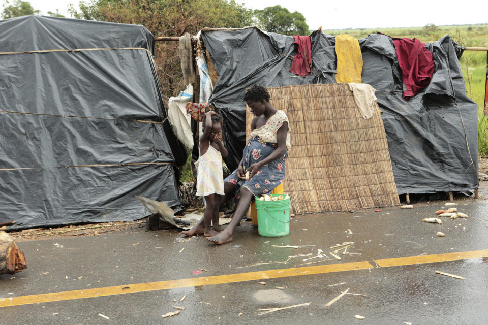 Survivors of Cyclone Idai in a makeshift shelter by the roadside near Nhamatanda about 50 kilometres from Beira, in Mozambique, Friday March, 22, 2019. As flood waters began to recede in parts of Mozambique on Friday, fears rose that the death toll could soar as bodies are revealed. (AP Photo/Tsvangirayi Mukwazhi)