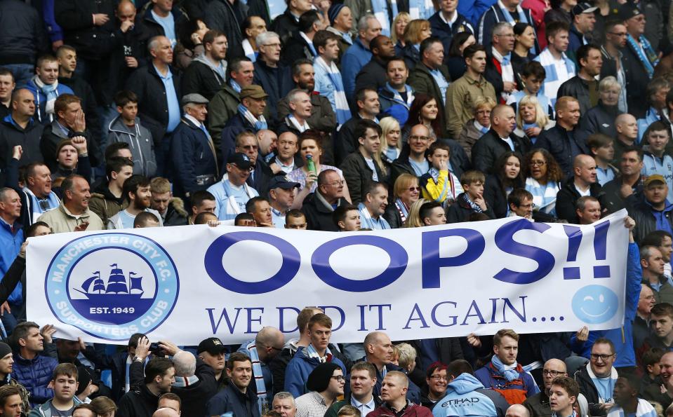 Manchester City fans hold a banner as their team take on West Ham United during their English Premier League soccer match at the Etihad Stadium in Manchester, northern England May 11, 2014. REUTERS/Darren Staples (BRITAIN - Tags: SPORT SOCCER) FOR EDITORIAL USE ONLY. NOT FOR SALE FOR MARKETING OR ADVERTISING CAMPAIGNS. NO USE WITH UNAUTHORIZED AUDIO, VIDEO, DATA, FIXTURE LISTS, CLUB/LEAGUE LOGOS OR "LIVE" SERVICES. ONLINE IN-MATCH USE LIMITED TO 45 IMAGES, NO VIDEO EMULATION. NO USE IN BETTING, GAMES OR SINGLE CLUB/LEAGUE/PLAYER PUBLICATIONS