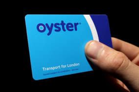 File photo dated 21/09/08 of a hand holding an Oyster pre-pay travelcard. London bus drivers will no longer accept cash payment on board their vehicles when new measures are introduced this summer. PRESS ASSOCIATION Photo. Issue date: Monday February 3, 2014. Transport for London (TfL) has announced a raft of changes, including allowing passengers with insufficient Oyster card credit to travel for a whole journey before they need to top up. See PA story TRANSPORT Oyster. Photo credit should read: Dominic Lipinski/PA Wire