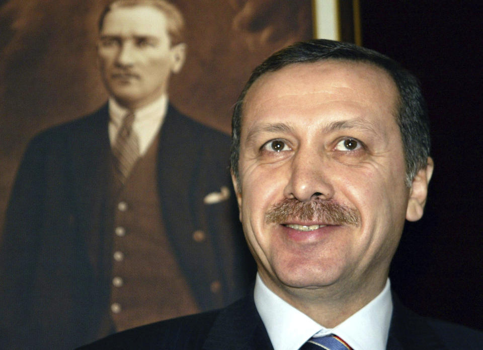 FILE - Turkish Prime Minister-designate Recep Tayyip Erdogan next to a portrait of Kemal Ataturk, founder of modern Turkey, during a press conference at the presidential palace in Ankara, on March 11, 2003. Erdogan, who is seeking a third term in office as president in elections in May, marks 20 years in office on Tuesday, March 14, 2023. (AP Photo/Anja Niedringhaus, File)