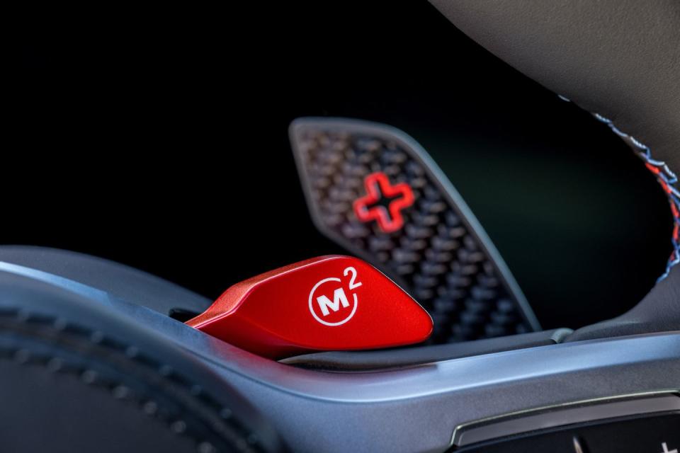 <p>Behind the selectable M mode buttons on the X5 M and X6 M's steering wheels are newly designed carbon-fiber shift paddles.</p>