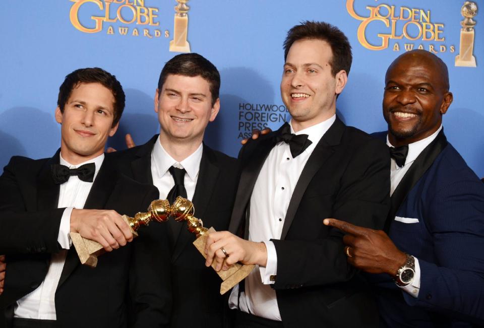 From left, Andy Samberg, Michael Schur, Dan Goor and Terry Crews pose in the press room with the award for best television series - comedy or musical for "Brooklyn Nine - Nine" at the 71st annual Golden Globe Awards at the Beverly Hilton Hotel on Sunday, Jan. 12, 2014, in Beverly Hills, Calif. (Photo by Jordan Strauss/Invision/AP)