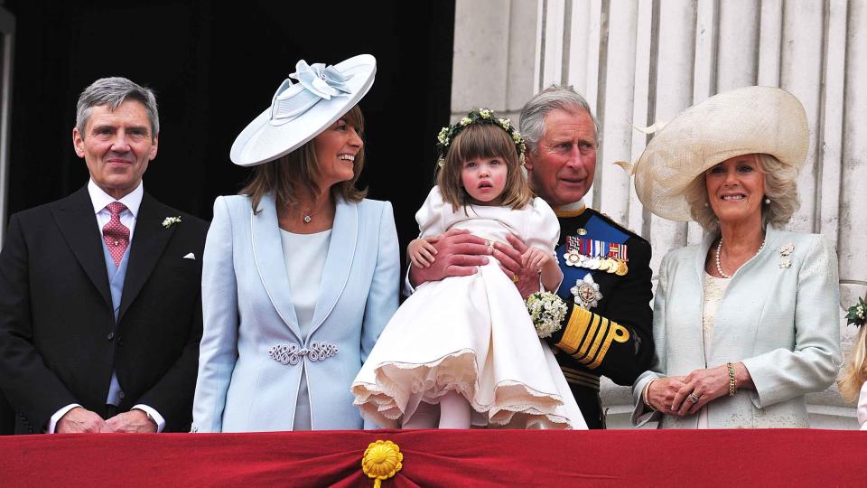Michael Middleton, Carole Middleton, Prince Charles, Prince of Wales holding bridesmaid Eliza Lopes and the Camilla, Duchess of Cornwall on the balcony at Buckingham Palace after the Royal Wedding of Prince William to Catherine Middleton on April 29, 2011 in London, England.  (John Stillwell / Getty Images)