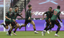 Aston Villa's Jack Grealish, centre,celebrates with teammates after scoring the opening goal of the game during the English Premier League soccer match between West Ham United and Aston Villa at the London Stadium in London, Sunday, July 26, 2020. (AP Photo/Matt Dunham)