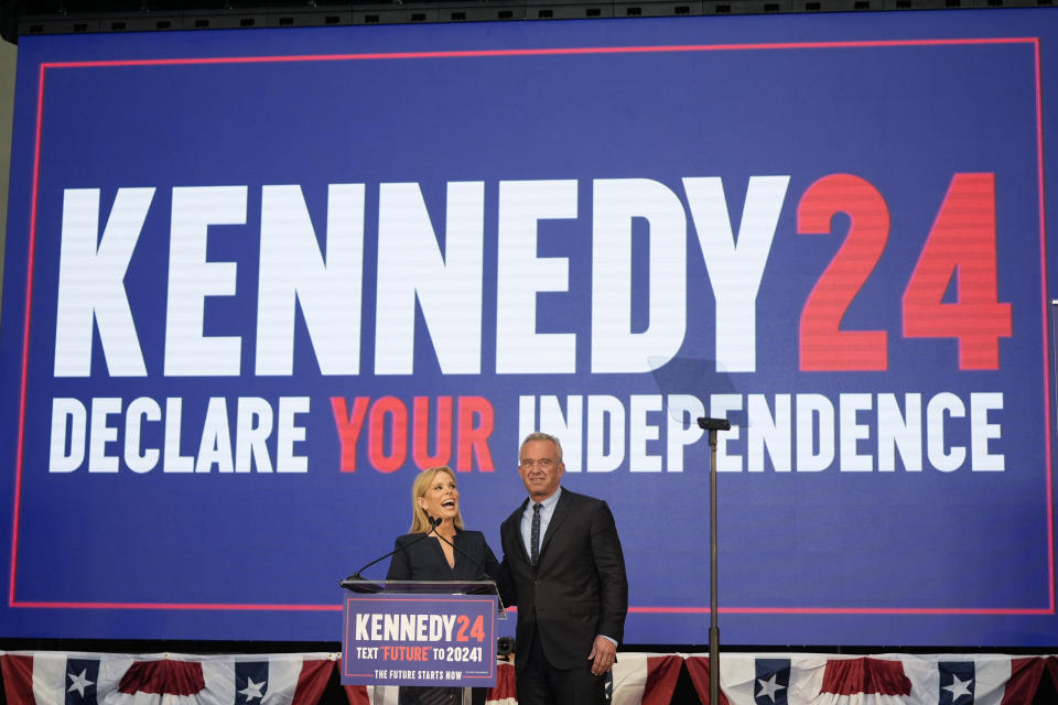 Presidential candidate Robert F. Kennedy Jr. right, is joined on the stage by his wife Cheryl Hines during a campaign event, Tuesday, March 26, 2024, in Oakland, Calif. (AP Photo/Eric Risberg)