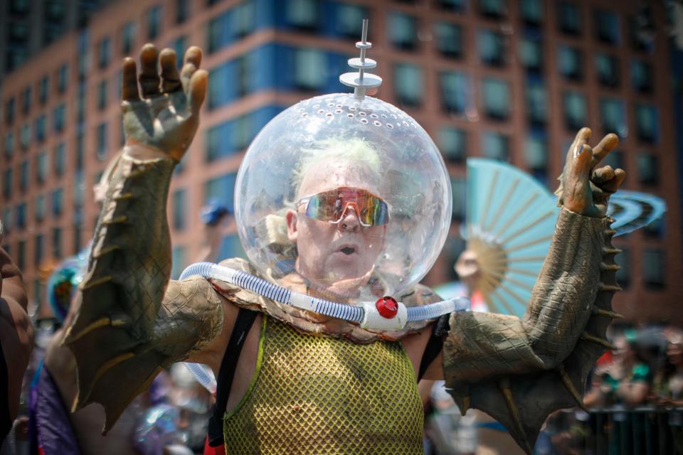 A man dressed in an underwater and outer space themed costume marches in the Coney Island Mermaid Parade on June 22, 2024 in New York City.