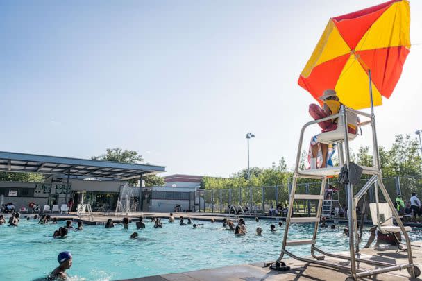 PHOTO: A lifeguard watches over people swimming at the Emancipation Swimming Pool in Houston, Texas, July 19, 2022. (Brandon Bell/Getty Images)