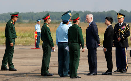 U.S. Secretary of Defense Jim Mattis (3rd R) talks with Vietnamese military officials while he visits Bien Hoa airbase, where the U.S. army stored the defoliant Agent Orange during the Vietnam War, in Bien Hoa city, outside Ho Chi Minh City, Vietnam October 17, 2018. REUTERS/Kham/Pool