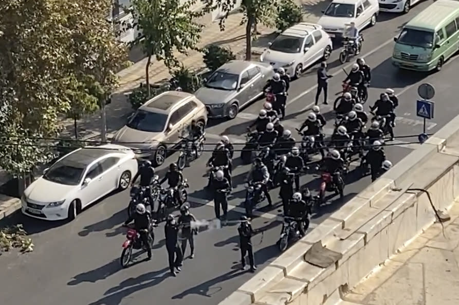 In this frame grab from video taken by an individual not employed by the Associated Press and obtained by the AP outside Iran shows Iranian police arrive to disperse a protest to mark 40 days since the death in custody of 22-year-old Mahsa Amini, whose tragedy sparked Iran's biggest antigovernment movement in over a decade, in Tehran, Iran, Wednesday, Oct. 26, 2022. (AP Photo)