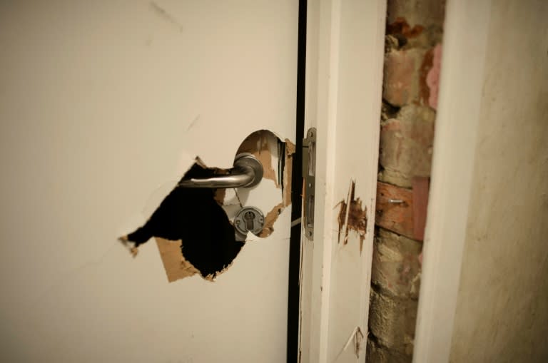 A picture shows the door which was forced open by Belgian police during an anti-terror raid in Verviers on November 26, 2015