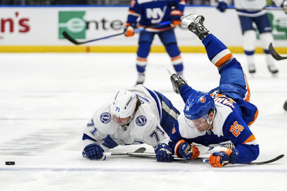 New York Islanders' Oliver Wahlstrom (26) battles for control of the puck with Tampa Bay Lightning's Anthony Cirelli (71) during the first period of an NHL hockey game Saturday, Feb. 24, 2024, in Elmont, N.Y. (AP Photo/Frank Franklin II)