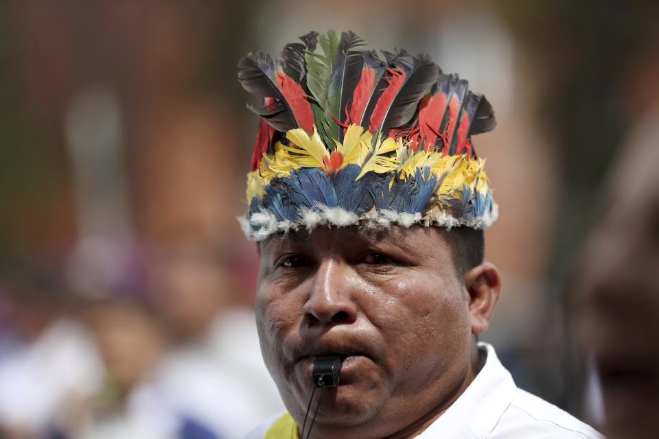 An indigenous man blows on a whistle during a national strike in Bogota, Colombia, Wednesday, Dec. 4, 2019. Colombia’s recent wave of demonstrations began with a massive strike on Nov. 21 that drew an estimated 250,000 people to the streets. Protests have continued in the days since but at a much smaller scale. (AP Photo/Fernando Vergara)