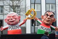 <p>A carnival float, depicting Polish President Andrzej Duda and Hungarian President Janos Ader holding a hammer and sickle, is pictured during a carnival parade on Rose Monday on Feb. 12, 2018 in Duesseldorf, western Germany. The writing (C) reads “right dictatorships”. Germany. (Photo: Patrik Stollarz/Getty Images) </p>