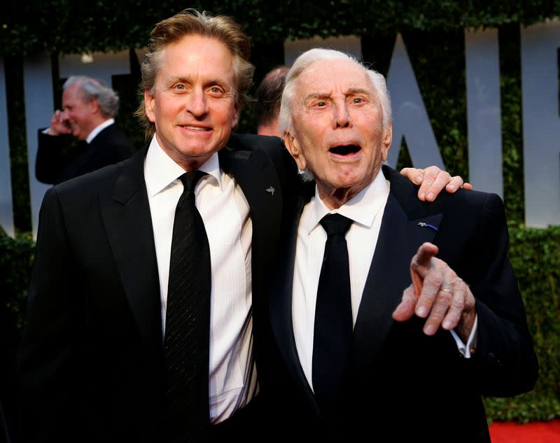 FILE PHOTO: Actor Michael Douglas and his father, actor Kirk Douglas, arrive together at the 2009 Vanity Fair Oscar Party in West Hollywood, California