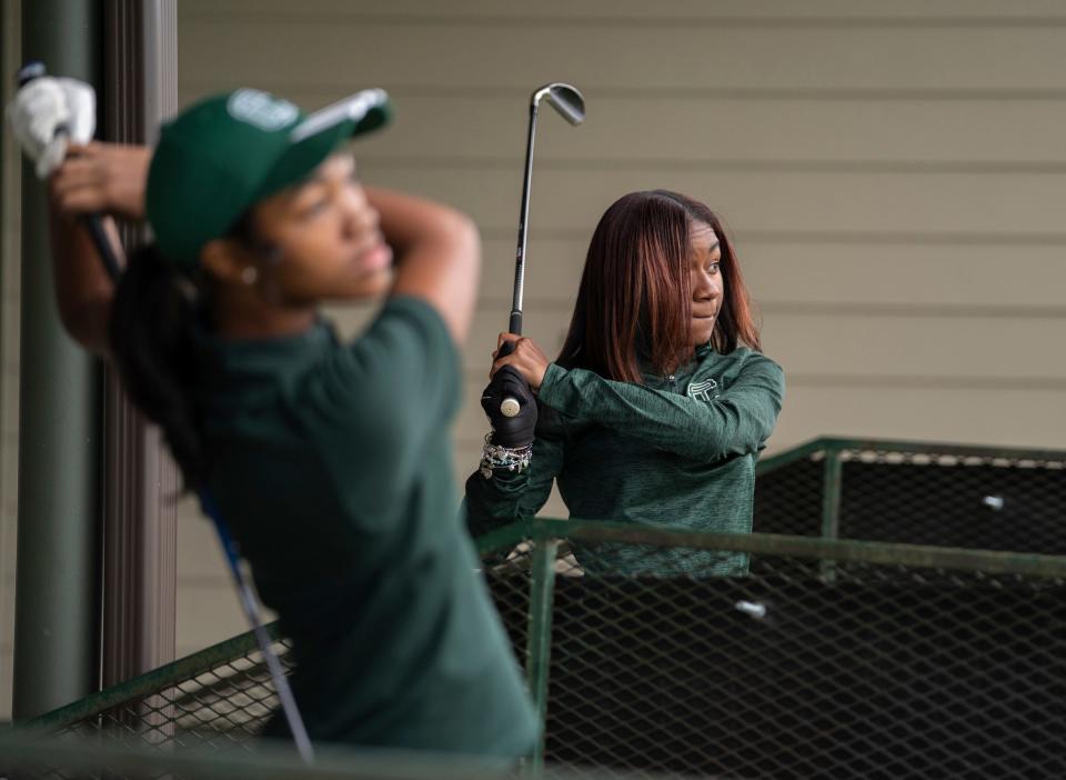 Cass Tech varsity golf player Kennedy Watts, right, and teammate Kalista Bennett hit balls at the Royal Oak Golf Center in Royal Oak on Tuesday, October 17, 2023, before their Division 1 State Championship Tournament this weekend. Cass Tech is the first girl's team from Detroit to reach that level and the team is only three years old.