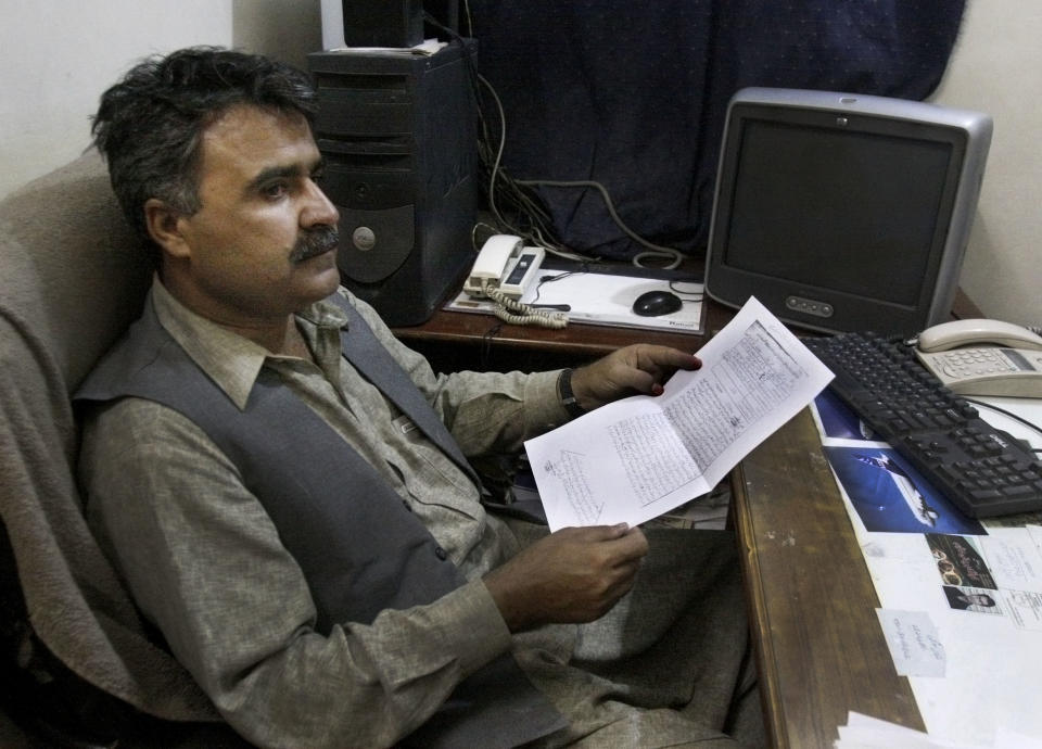 In this Thursday, Sept. 13, 2012 photo, Baluchistan Union of Journalists President Essa Tareen looks at the charge sheet that the Pakistani government has filed against the journalists in his office in Quetta, Pakistan. The telephone call to local journalists generally comes in the late evening. The voice on the other end is usually a Sunni militant with a statement he wants printed threatening of violence or claiming responsibility for attacks that already occurred. Journalists fear being killed if they don't print the messages. (AP Photo/Arshad Butt)