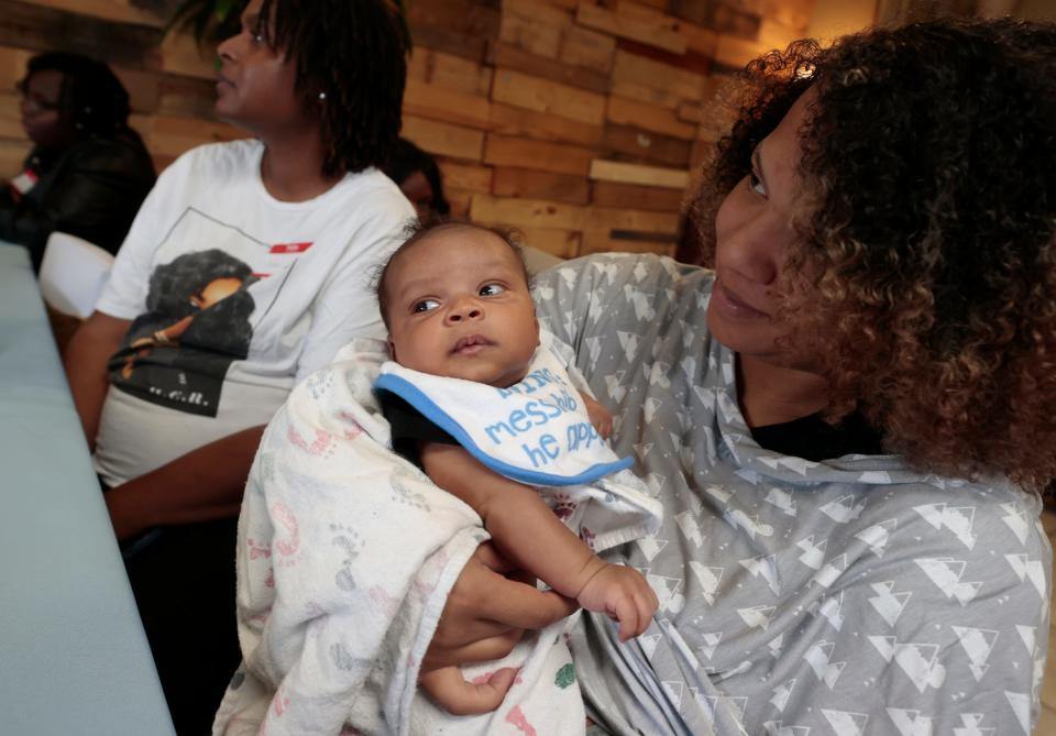 Serenity Jackson, 22 of Detroit with her 6-week-old son, Samuel Metoyer during a baby shower Lesley and Robert Gant of Because of His Love Outreach hosted at Harmony Café in Detroit on May 20, 2023. The Gants hosted the shower for expecting parents and moms who had recently given birth, had a raffle of baby items and gift bags full of diapers and other baby supplies.