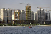 This July 6, 2019 photo shows residential towers in District 22, that consists of apartment high-rises and shopping malls arranged around an artificial lake called Chitgar, under construction on the northwestern edge of Tehran, Iran. Iran’s large middle class has been hit hard by the fallout from unprecedented U.S. sanctions, including the collapse of the national currency. Perhaps most devastating has been the doubling of housing prices. The spike has uprooted tenants and made home ownership unattainable for most. (AP Photo/Ebrahim Noroozi)