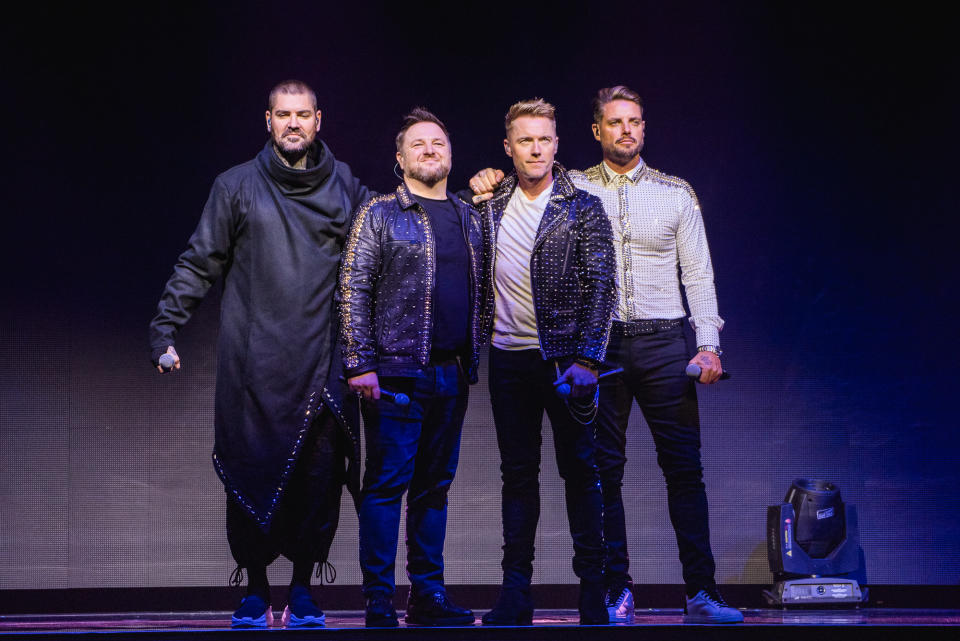 LONDON, ENGLAND - OCTOBER 21:  (EDITORIAL USE ONLY) (L-R) Shane Lynch, Mikey Graham, Ronan Keating and Keith Duffy of Boyzone perform on stage during 