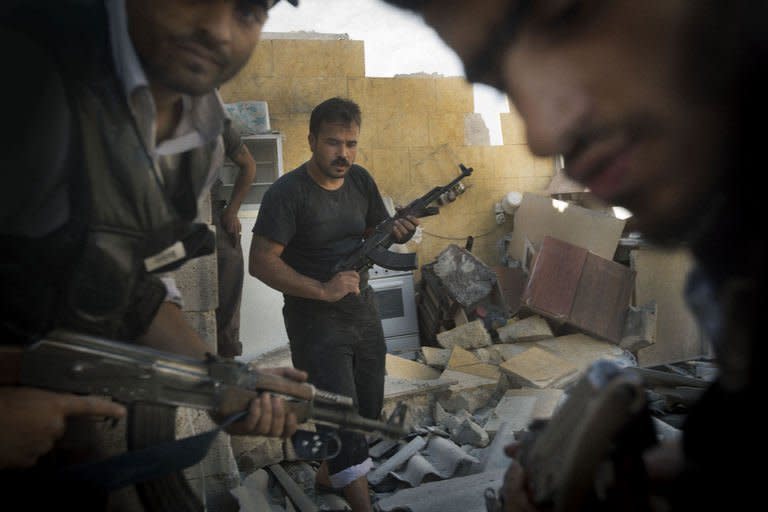 Syrian opposition fighters are seen in the northern city of Aleppo on May 27, 2013. Russia insisted Tuesday it would deliver anti-aircraft missiles to Syria despite international criticism, as fears of spillover from the conflict grew after three Lebanese soldiers were killed in a border-area attack