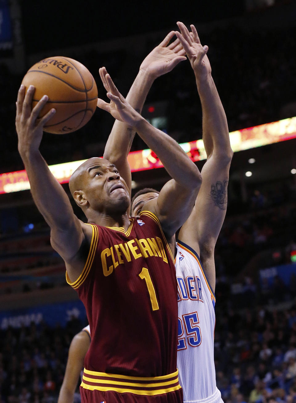 Cleveland Cavaliers guard Jarrett Jack (1) shoots in front of Oklahoma City Thunder guard Thabo Sefolosha (25) during the first quarter of an NBA basketball game in Oklahoma City, Wednesday, Feb. 26, 2014. (AP Photo/Sue Ogrocki)