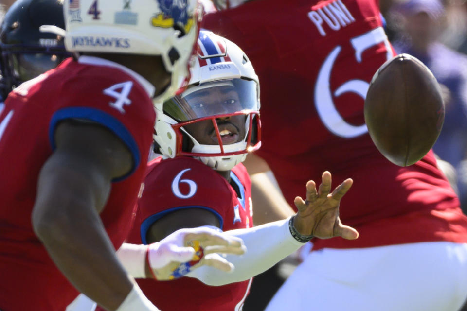 FILE - Kansas quarterback Jalon Daniels (6) pitches out to running back Devin Neal (4) during the first half of an NCAA college football game against TCU, Oct. 8, 2022, in Lawrence, Kan. The Jayhawks have dual-threat Daniels back after he missed four games and Neal averages 6.2 yards per carry for Kansas with 1,061 yards this season. (AP Photo/Reed Hoffmann, File)