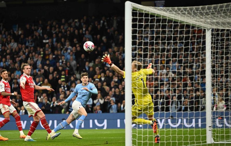 Manchester City’s John Stones scores their second goal past Arsenal’s Aaron Ramsdale.