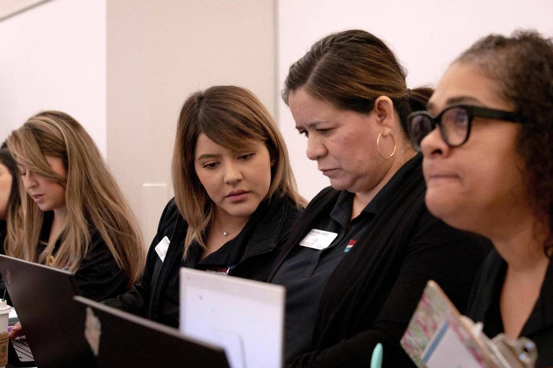 Onboarding technician Kassandra Nunez helps sign a teacher candidate to a school during the Fort Worth Independent School District Summer Mega Career Fair on June 7, 2022, at the FWISD Teaching & Learning Center.